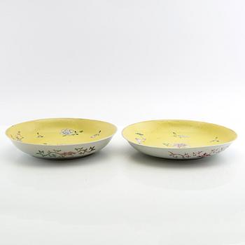 Two yellow ground dishes, Qing dynasty, circa 1900, with a Qianlong mark.