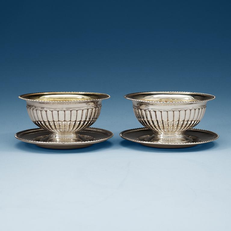 A pair of Swedish 19th century parcel-gilt sauce-bowls, makers mark of Gustaf Folcker, Stockholm 1837 and 1838.