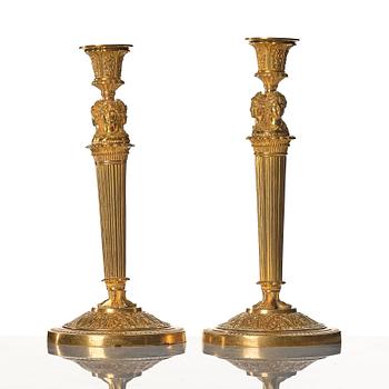 A pair of French Empire early 19th century gilt bronze candlesticks.