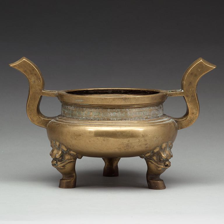 A large brass tripod censer, Qing dynasty (1644-1912).