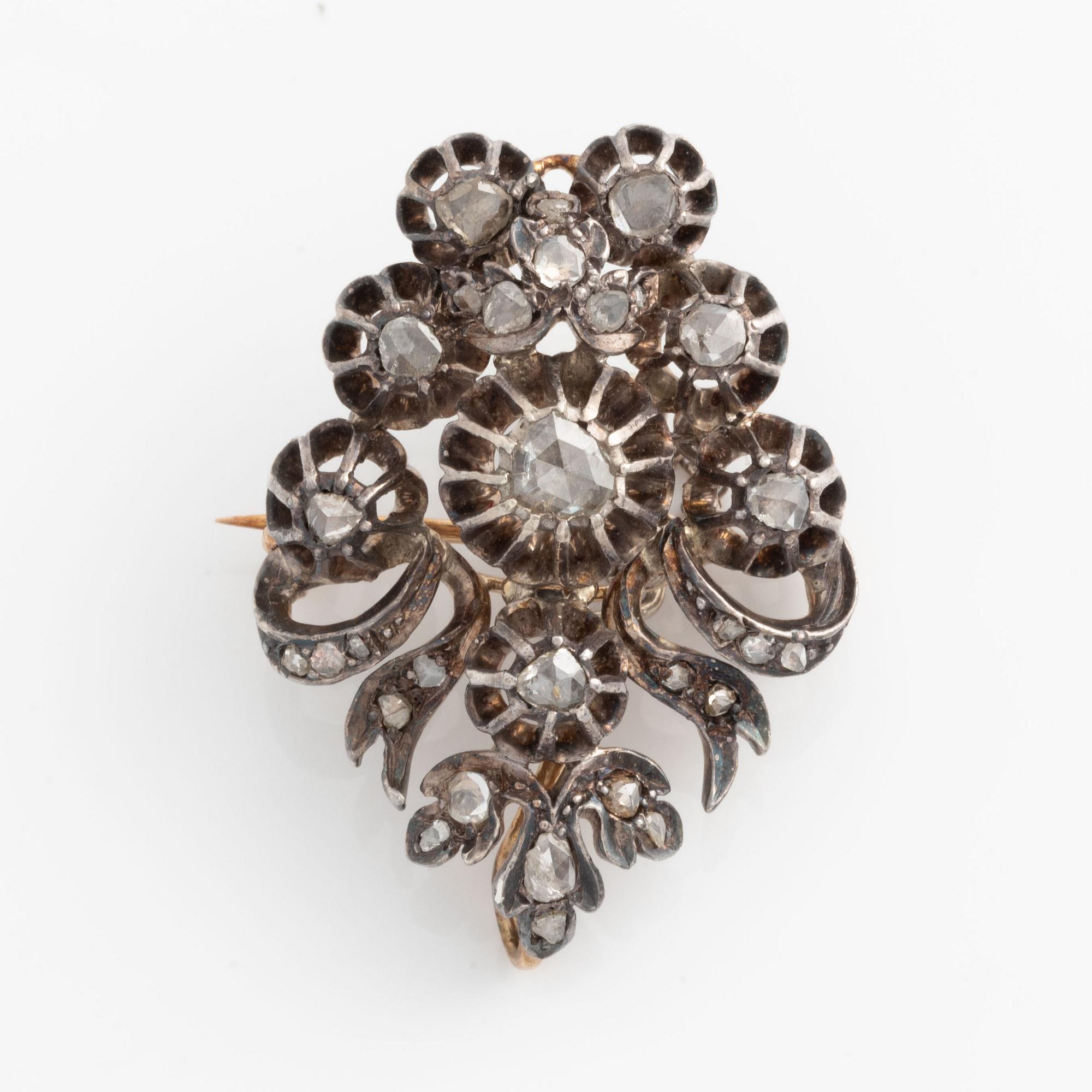 A silver brooch set with rose-cut diamonds.