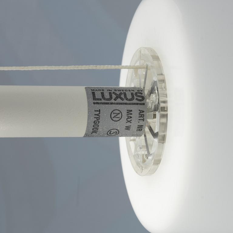 A white metal floor light, Luxus, Vittsjö.