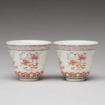 A pair of Chinese famille rose ba jixiang wine cups, Republic, with Guangxu six character mark.