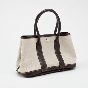 HERMÈS, a beige canvas and brown leather bag, "Garden Party".