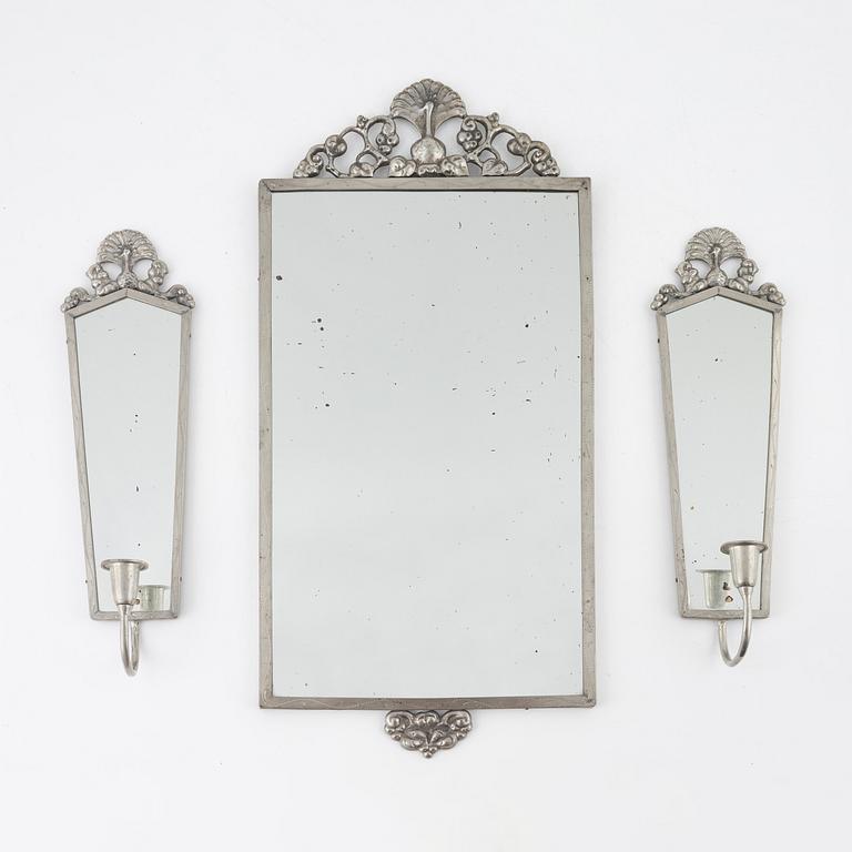 A pewter mirror with a pair of sconces, 1920's/30's.