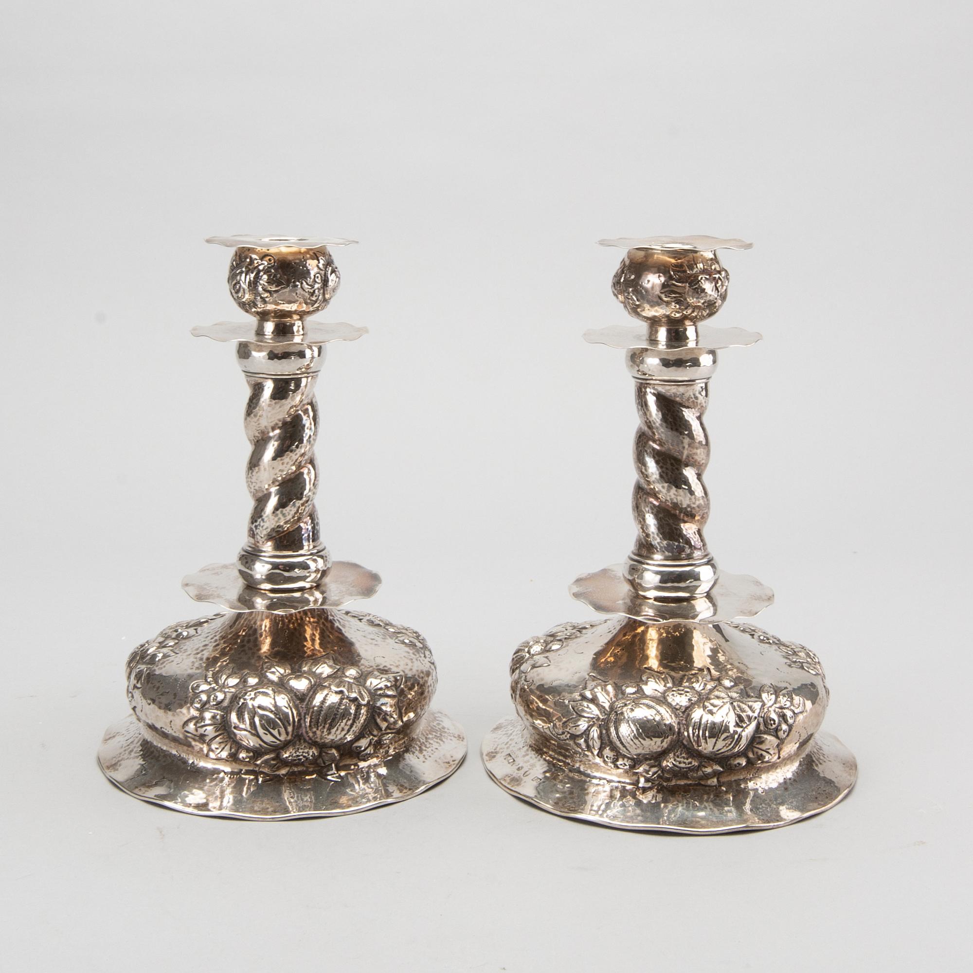 A pair of silver baroquestyle candlesticks. W.H.H, Stockholm. 1935. Filled foot.