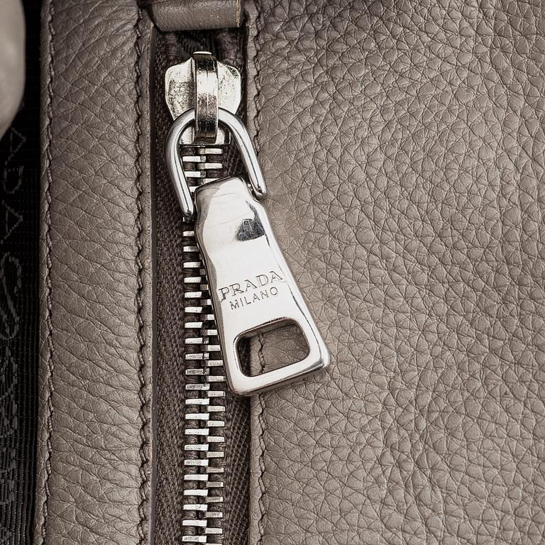 Prada, a leather handbag.