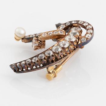 A 14K gold brooch set with old-cut diamonds and a pearl.