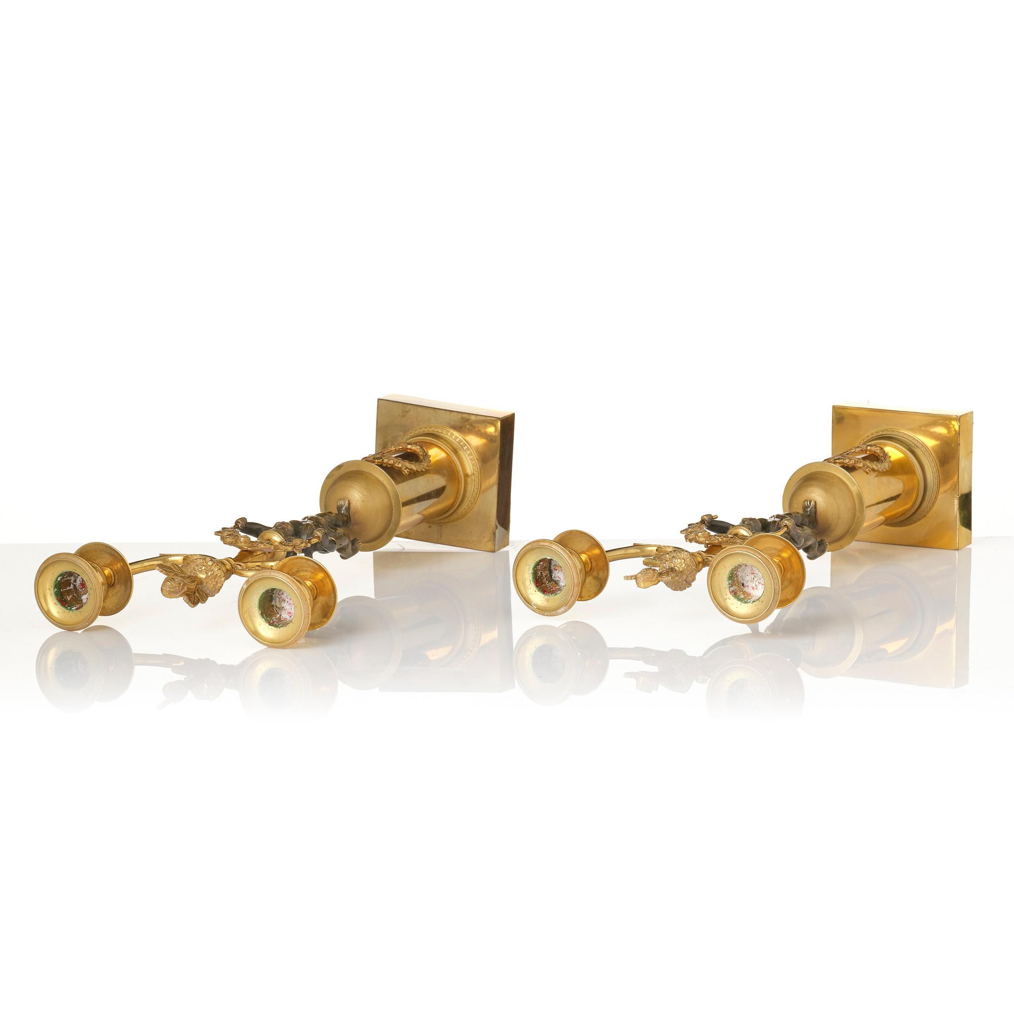 A pair of Empire gilt-brass two-branch candelabra, Stockholm, early 19th century.