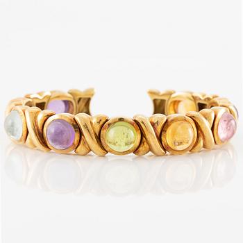 Bracelet in 18K gold set with cabochon-cut citrine, amethyst, pink tourmaline, peridot, and aquamarine.