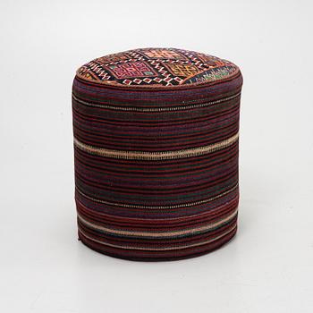A Kelim covered stool.