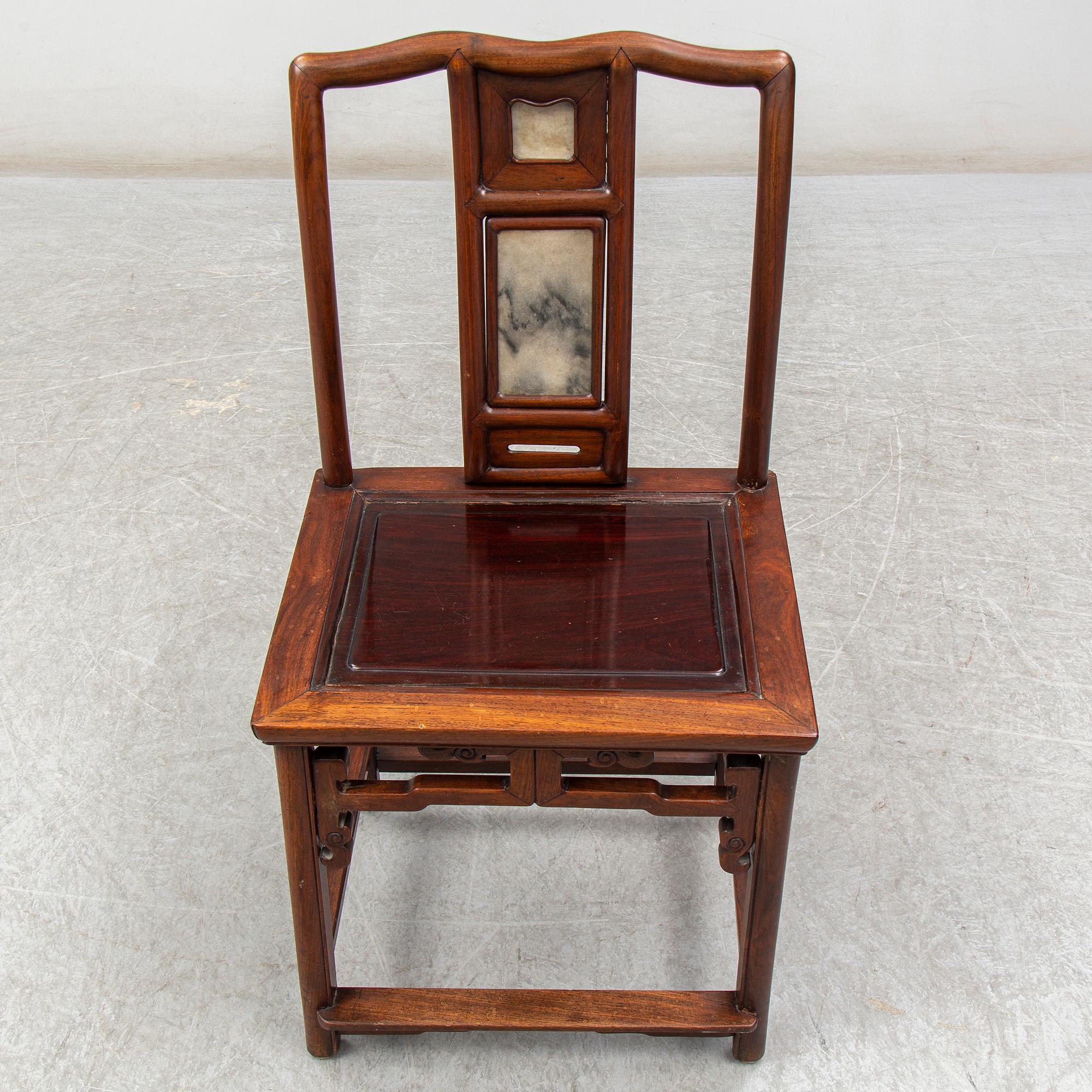 A pair of Chinese hardwood armchairs, early 20th century.