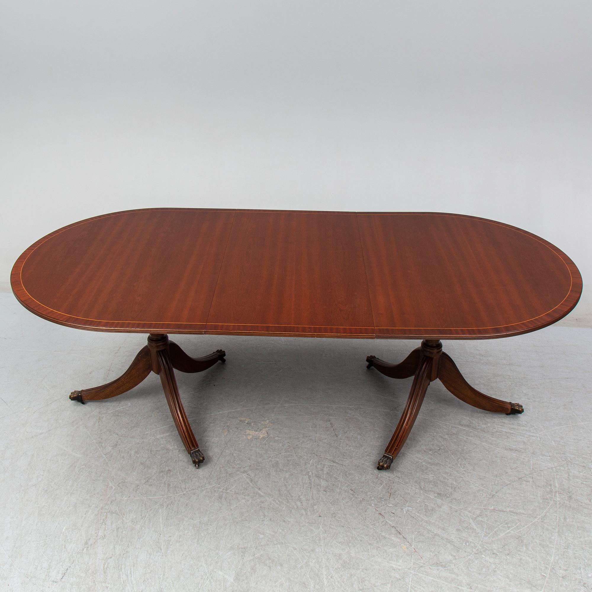 A late 20th century English dining table. One leaf included.