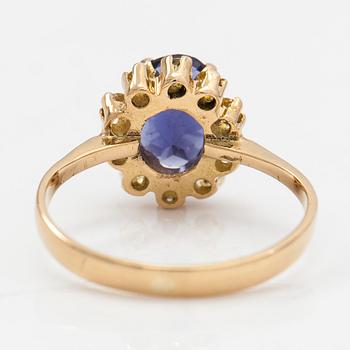 An 18K gold ring with a tanzanite and yellow sapphires.