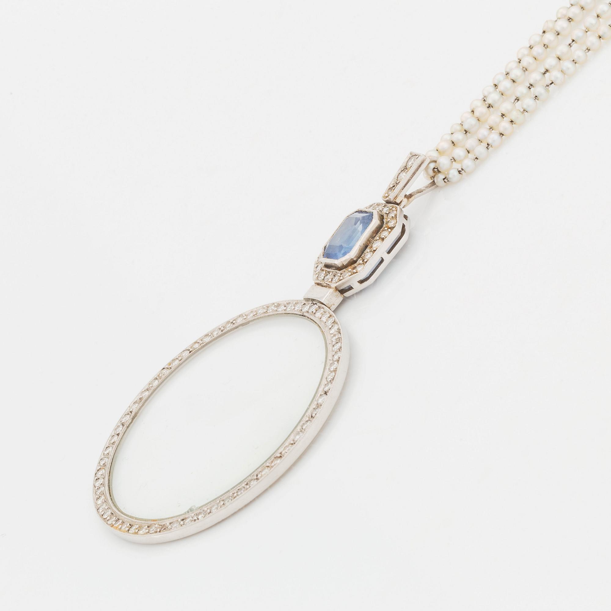 A platinum lorgnette set with a faceted sapphire and rose-cut diamonds.