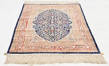 A Hereke silk rug, c. 130 x 71 cm.