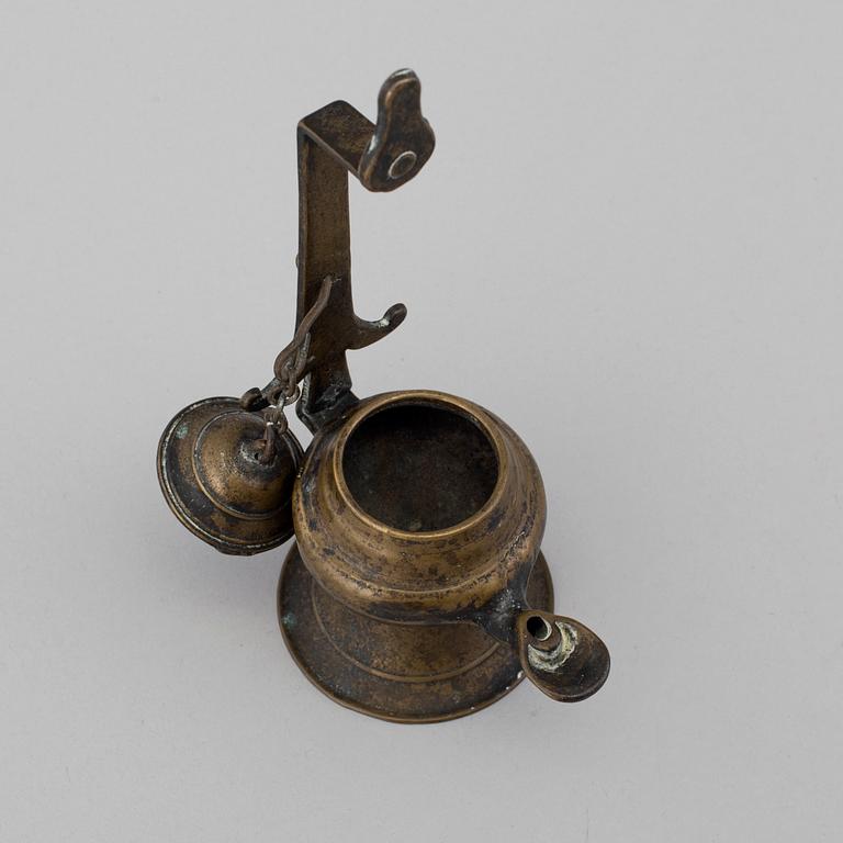 An 18th century bronze oil lamp.