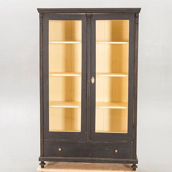 A painted early 1900s display cabinet.