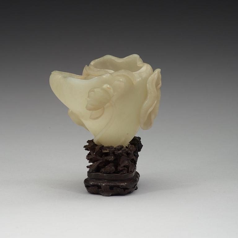 A nephrite brush washer, on a hardwood stand with silver inlay, Qing dynasty (1644-1912).