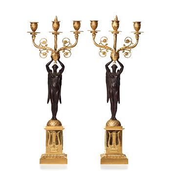 107. A pair of Empire three-light candelabra.