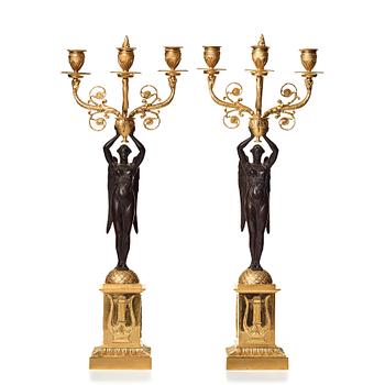 107. A pair of Empire three-light candelabra.