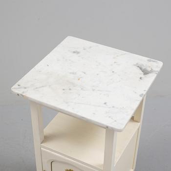 A early bedside table with marble top.