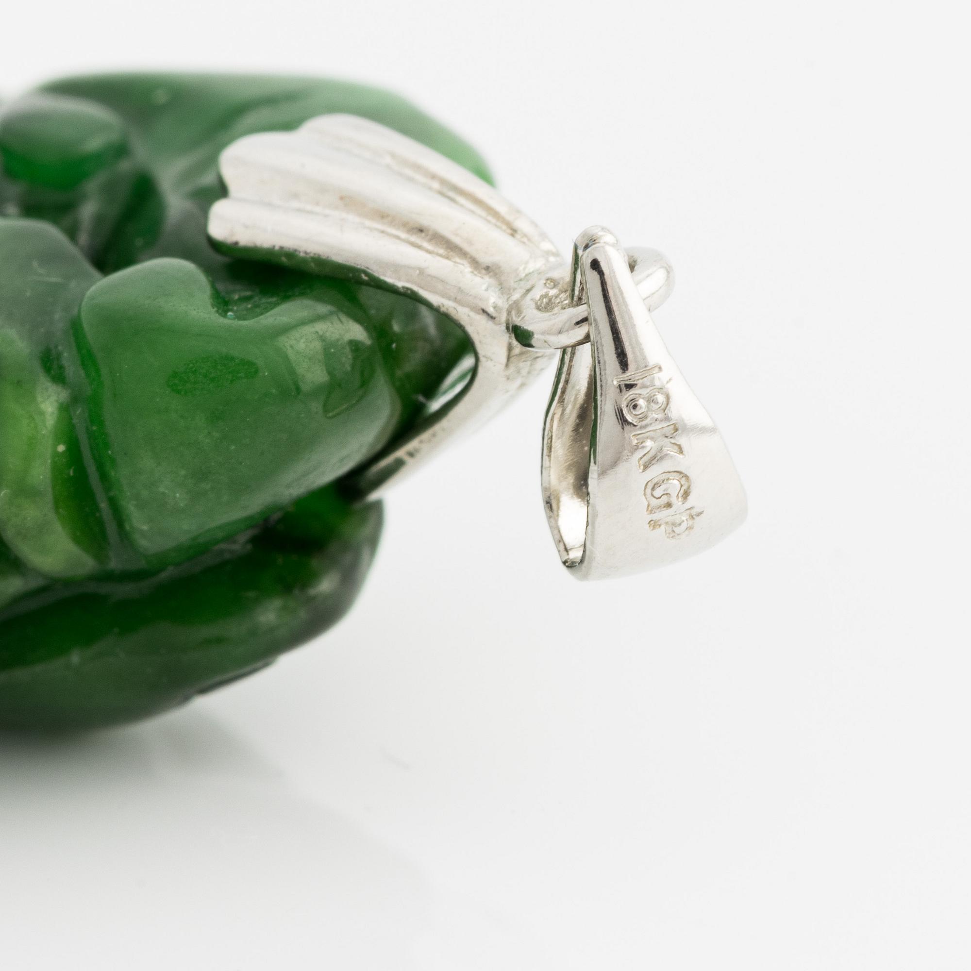 Pendant with carved green stone.