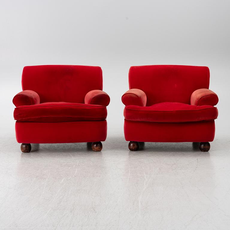 A pair of Howard-style armchairs and a footstool, late 20th century.