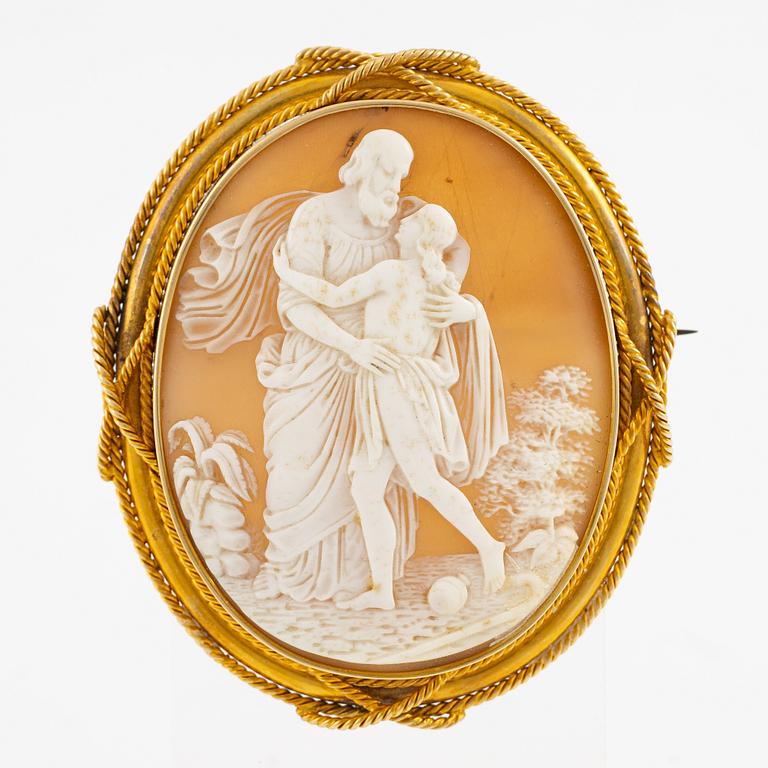 A brooch with a large shell cameo.