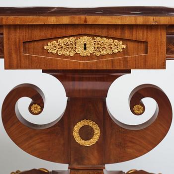 A Swedish Empire mahogany center table by Johan Öman, (Stockhom 1815-1833).