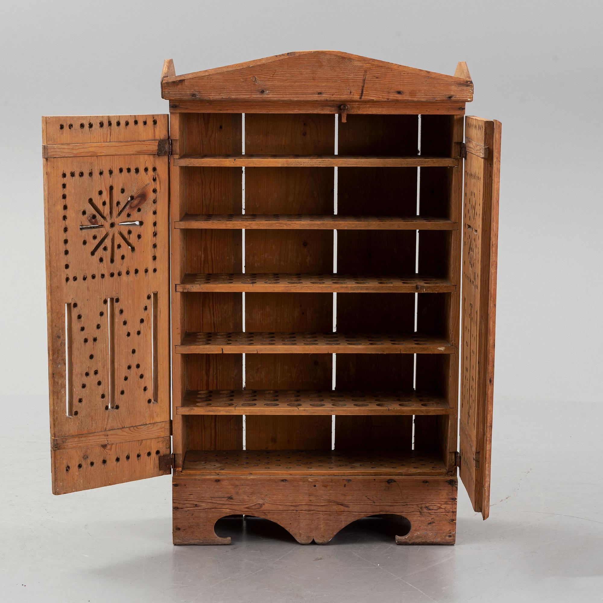 A late 19th century pine cupboard for eggs.