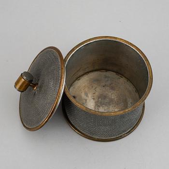 a pewter and brass jar with cover by Svenskt Tenn, Stockholm 1936.