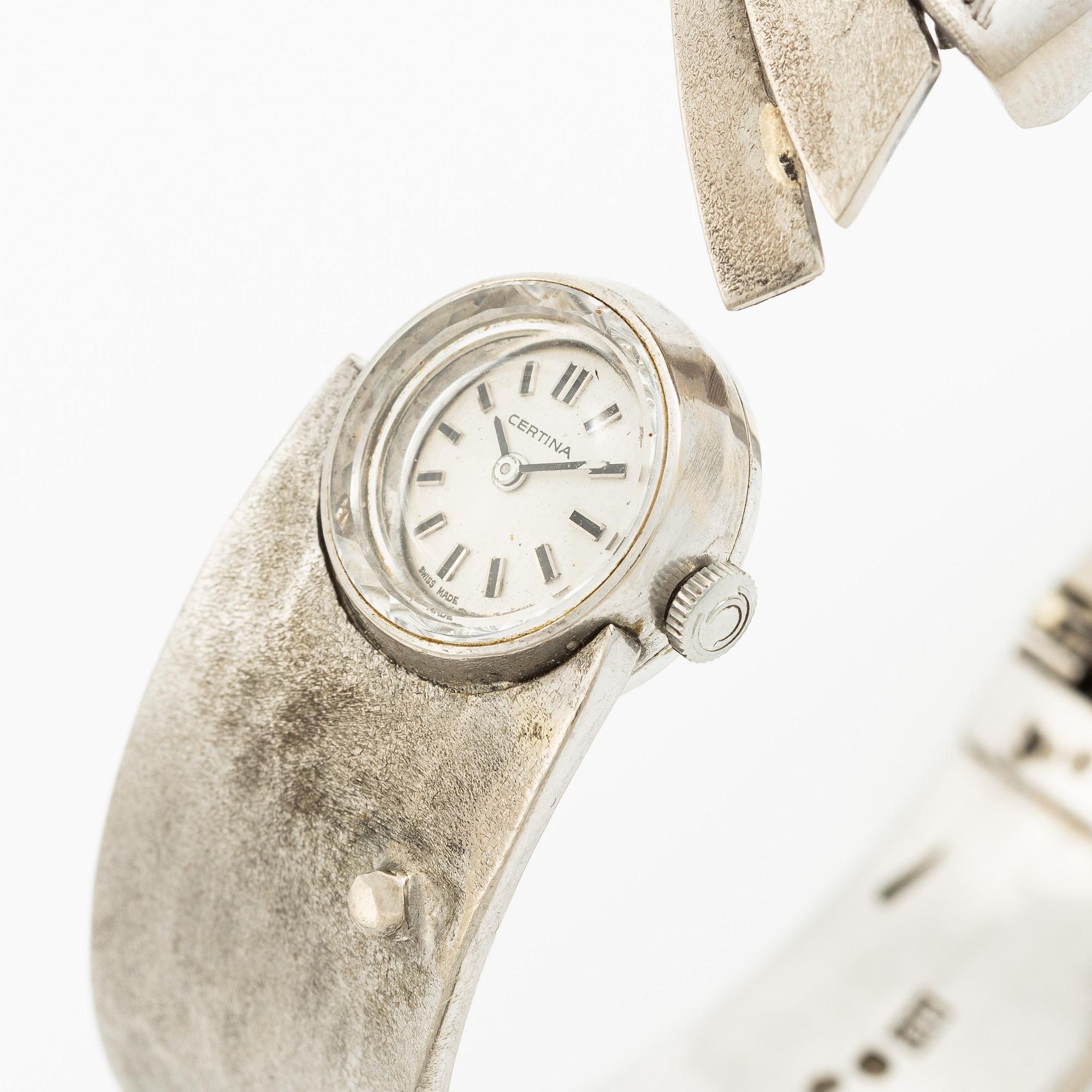 Aftonklocka/armring, Bo Dolk, 18K vitguld med briljantslipade diamanter, 1970-tal.