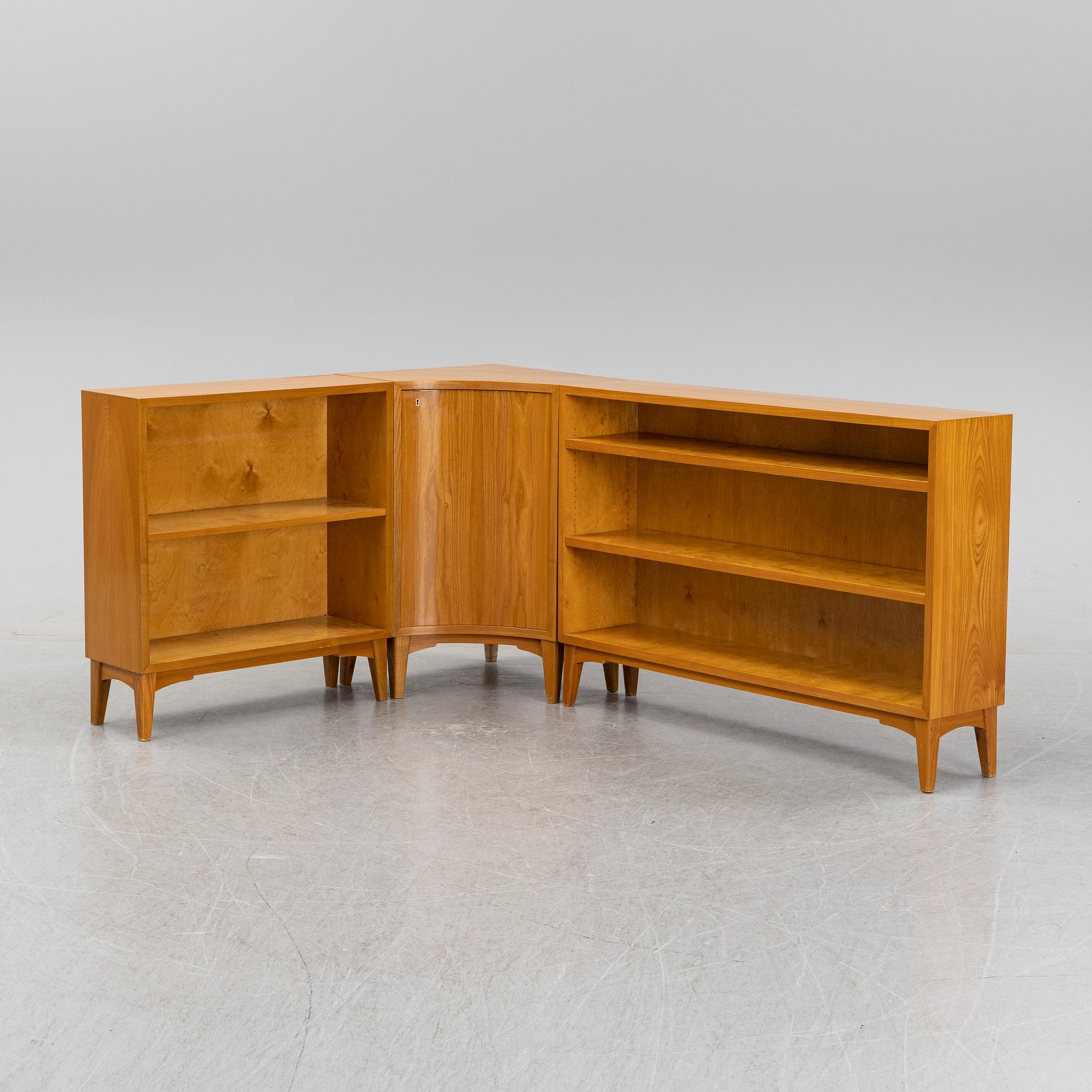 A three piece corner book case with a cabinet.