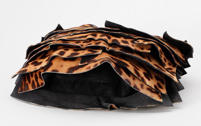 A leopard patterned pony skin handbag by Yves Saint Laurent.