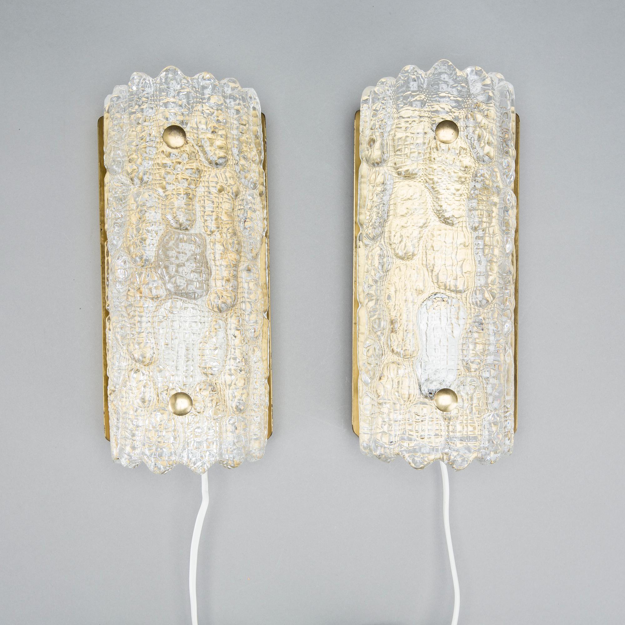 CARL FAGERLUND, a pair of glass and brass Orrefors wall lamps.