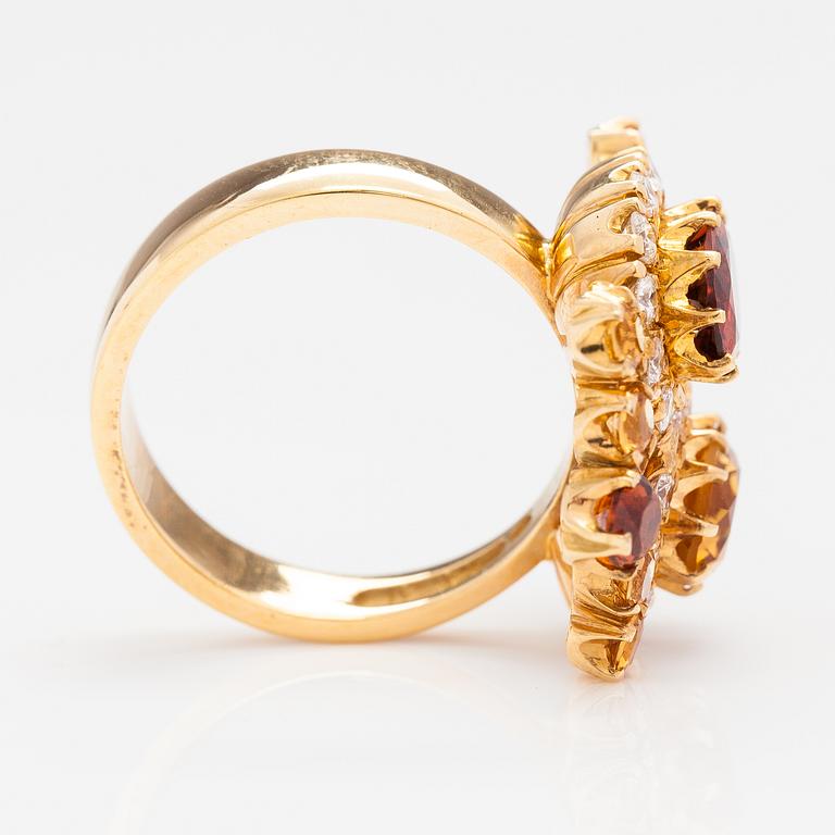 An 18K gold ring "Sophia Albertina", garnets, citrines, diamonds ca. 0.54 ct in total. Ofelia Jewelry, Helsinki 1998.