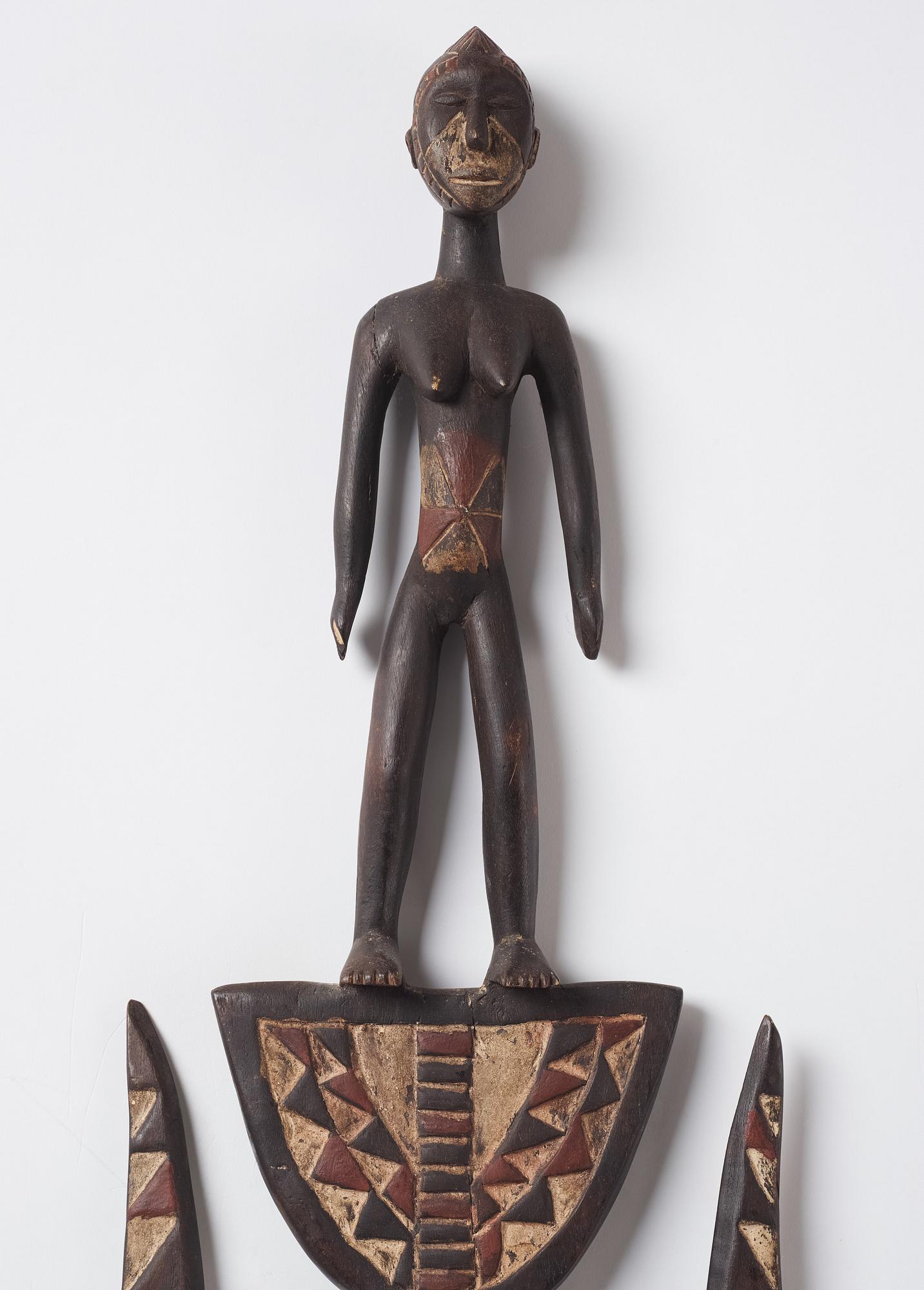 A sculptue and two masks reportedly from The Ivory coast, from the second half of the 20:th century.