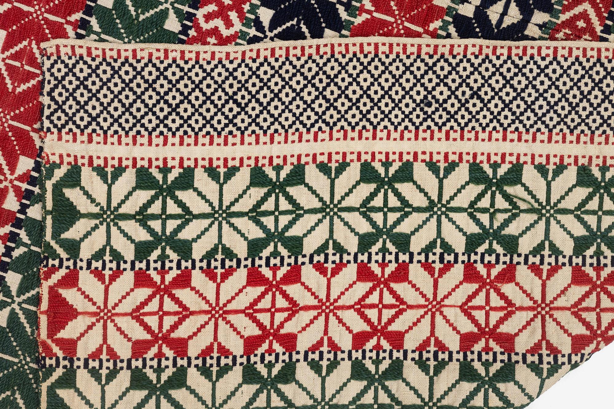 A bed cover in weft-patterned tabby type, c. 180 x 126, Scania, Sweden, first half of the 19th century.