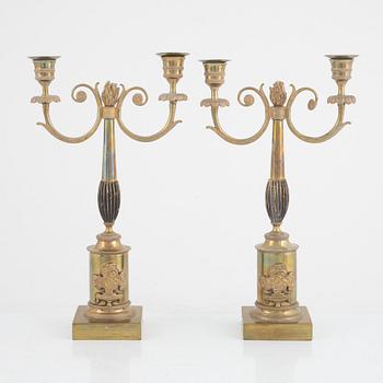 A pair of Swedish Empire two-branch gilt-brass candelabra, 1820's/30's.