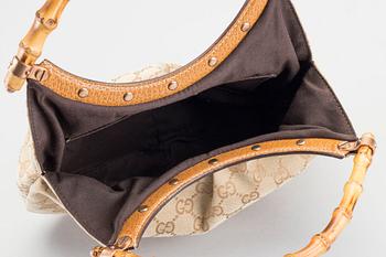 A GUCCI BAG, "STUDDED  BAMBOO HANDLE".