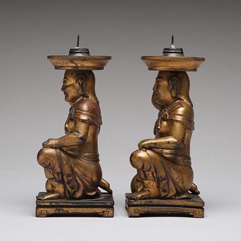 A pair of gilt lacquered candle holders, late Qing dynasty.