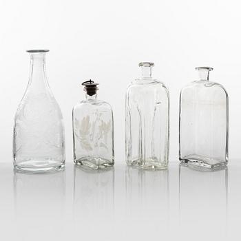 A set of three glass bottles and one decanter, 19th Century.