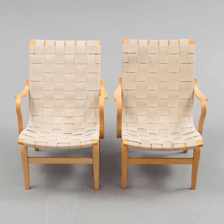 a pair of "Eva" armchairs by Bruno Matsson.