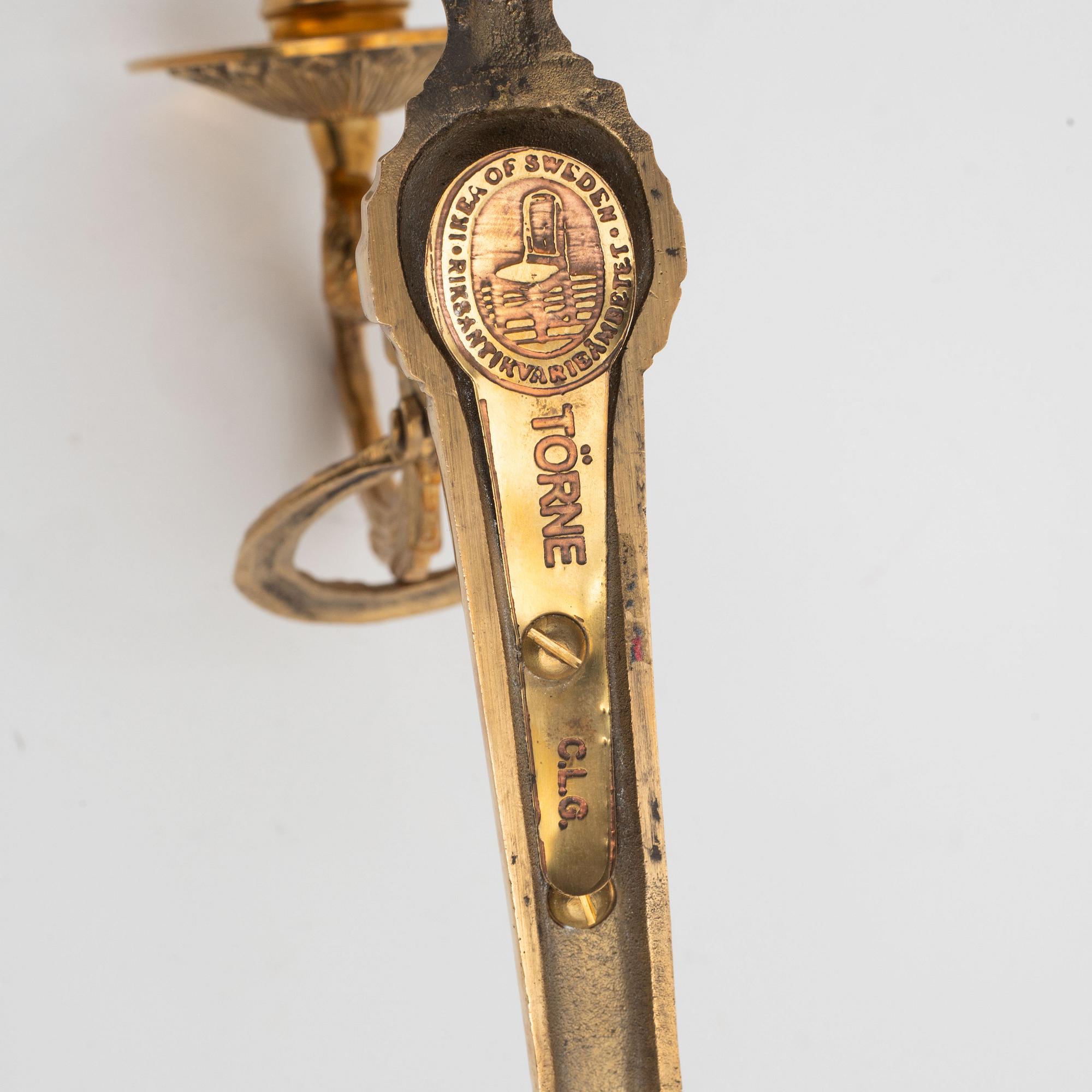 A pair of 'Törne' brass one-light wall ligths from IKEA's 18th Century collection.