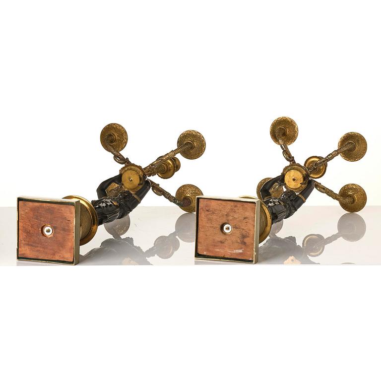 A pair of Fernch Empire ormolu and patinated bronze five-light candelabra, early 19th century.