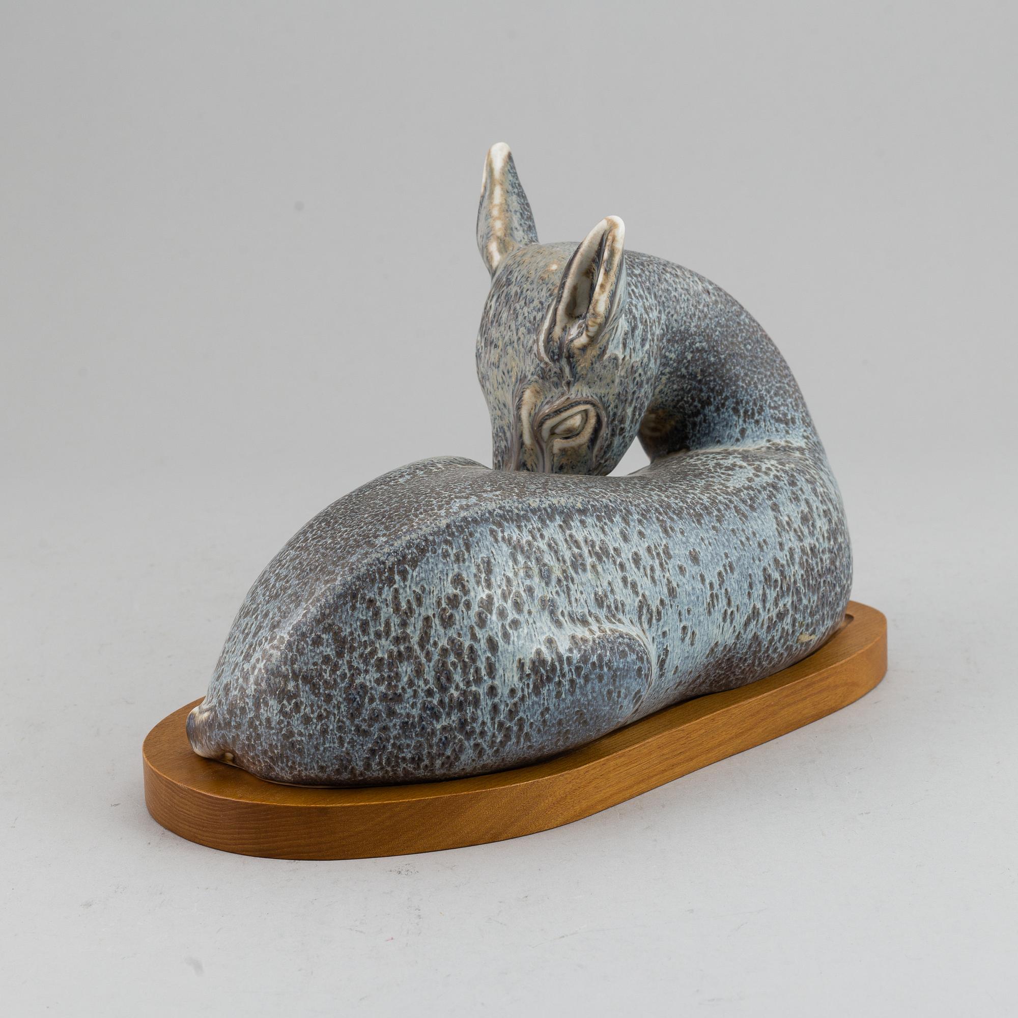 GUNNAR NYLUND, a unique stoneware sculpture of a reclining deer, Rörstrand, Sweden mid 20th Century.