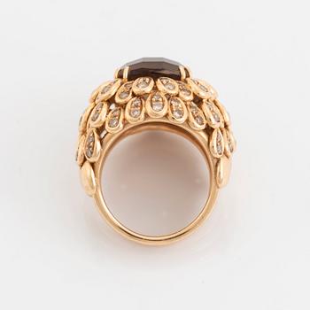 An 18K gold and smoky quartz ring set with round brilliant-cut diamonds.