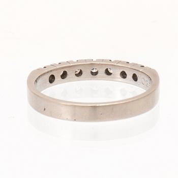 A half eternity ring in 18K white gold set with round brilliant-cut diamonds.