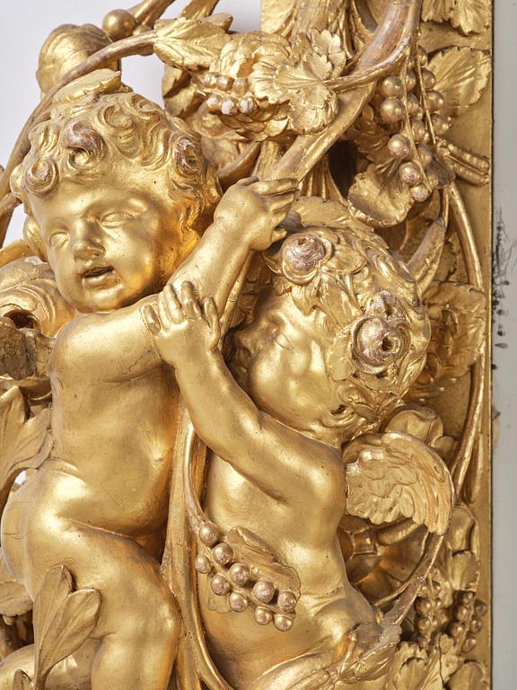 A presumably Dutch Louis XIV carved giltwood frame with mirror glass, in the style of Jean Le Pautre, late 17th century.